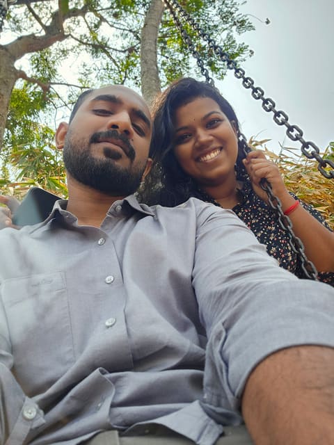 Sneha on the swing holding the chain, Hari in the foreground